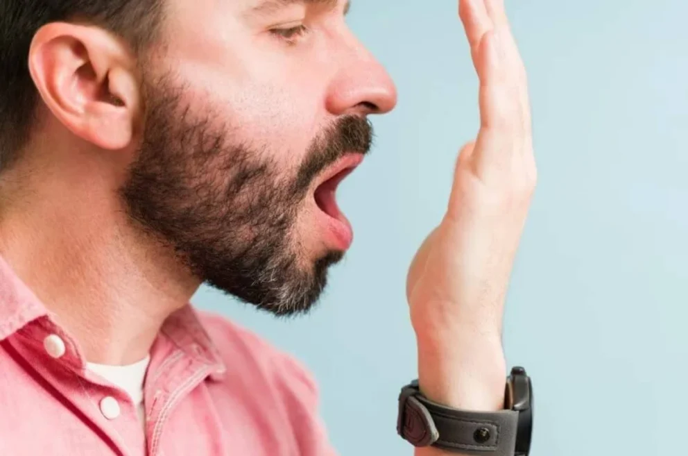 Persona che percepisce il suo alito cattivo, segnale tipico dell’alitosi