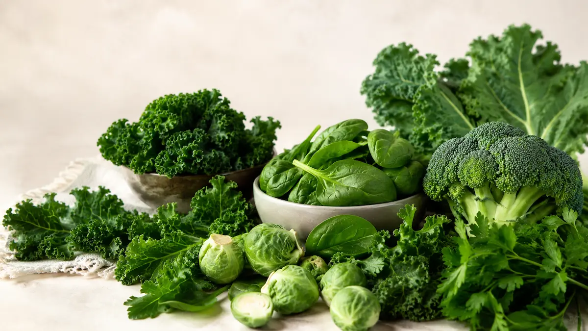 Alimenti ricchi di vitamina K: cavolo riccio, spinaci, broccoli e verdure verdi.